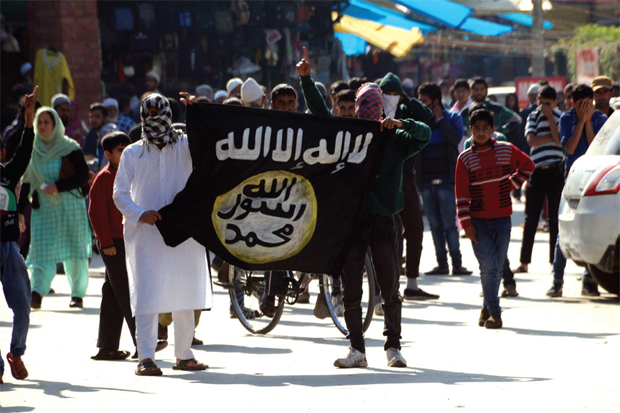 Symbol of terror Masked youth show off the IS flag in downtown Srinagar